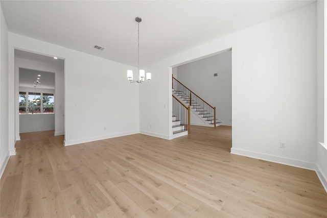 2305 Shane Ranch Dr, Cedar Park, TX 78641 - empty room with a chandelier, light wood-style floors, and stairs