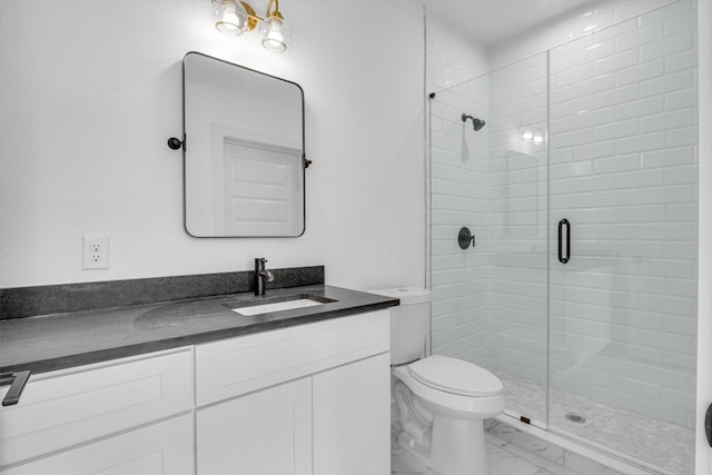 bathroom with toilet, an enclosed shower, and vanity