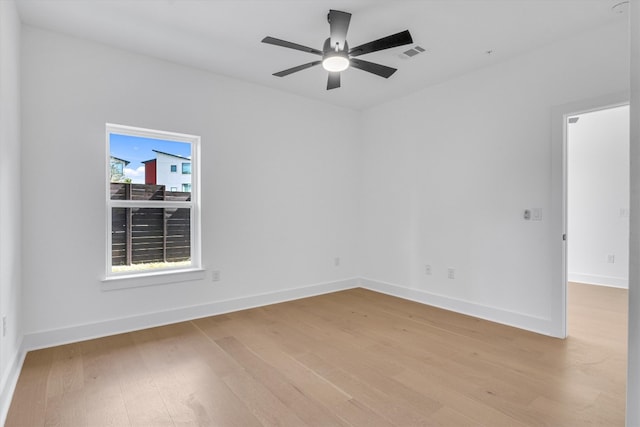 spare room featuring light hardwood / wood-style floors and ceiling fan