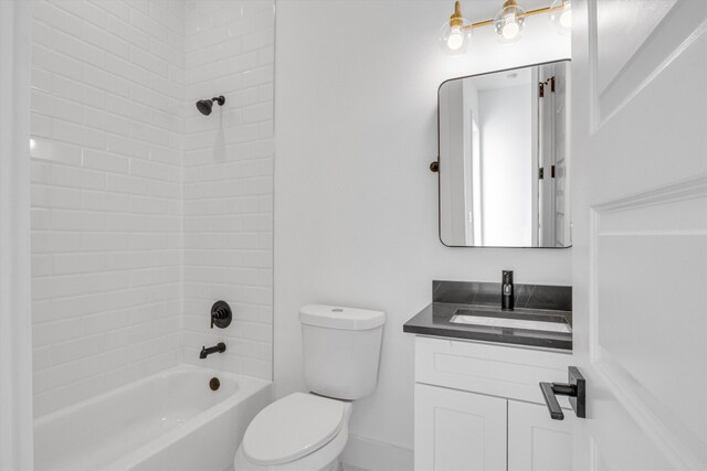 full bathroom with vanity, tiled shower / bath, and toilet