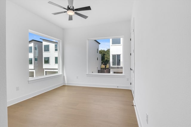 spare room featuring light wood-type flooring and ceiling fan