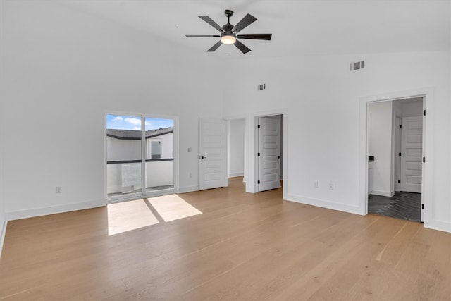 unfurnished living room featuring light hardwood / wood-style flooring, high vaulted ceiling, and ceiling fan