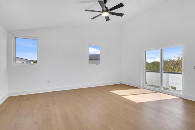 spare room with ceiling fan, vaulted ceiling, and light hardwood / wood-style flooring