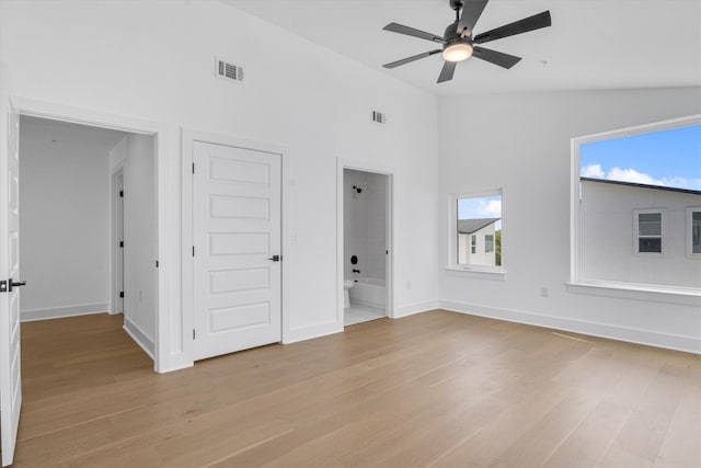 unfurnished living room with a healthy amount of sunlight and light hardwood / wood-style flooring