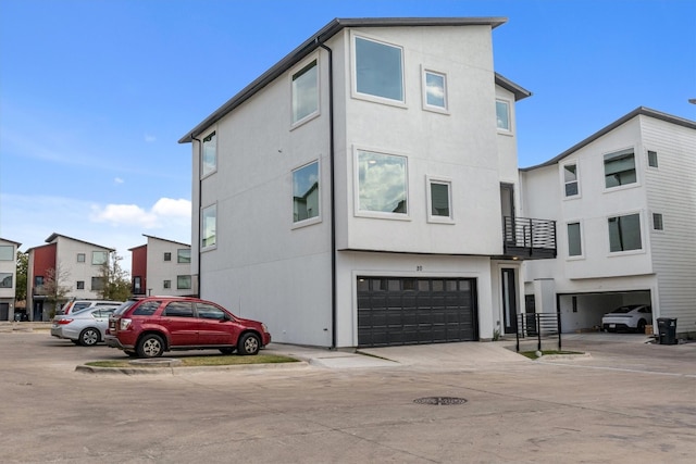 exterior space with a garage and a balcony