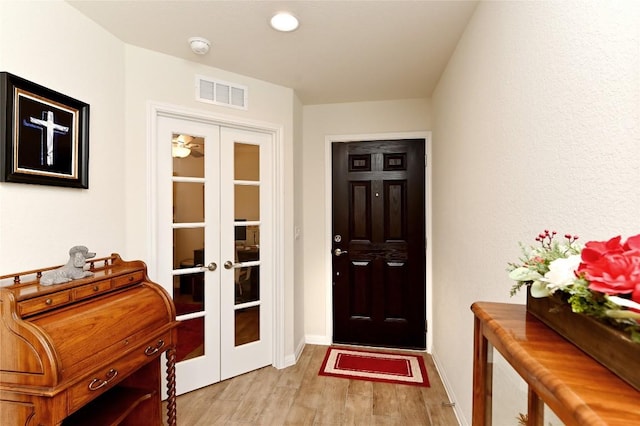 doorway featuring light hardwood / wood-style floors and french doors