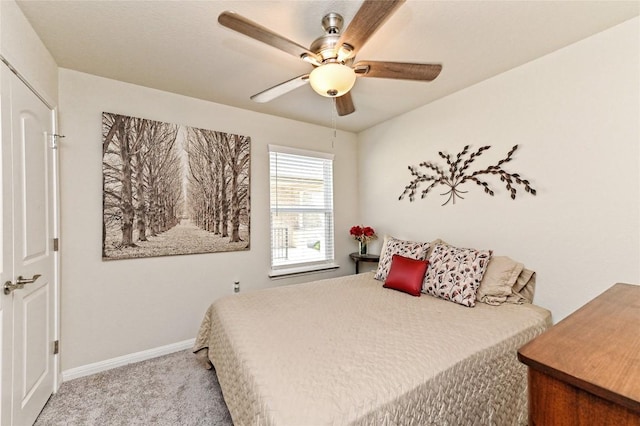 bedroom with ceiling fan, light carpet, and a closet