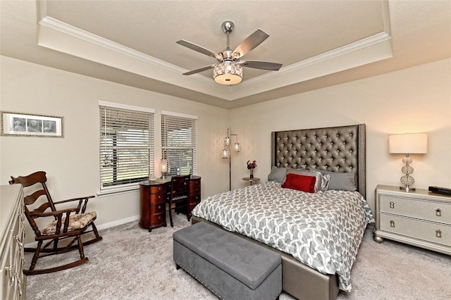 carpeted bedroom with a raised ceiling, ceiling fan, and ornamental molding