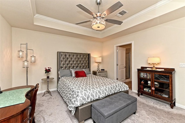 carpeted bedroom featuring ceiling fan, a raised ceiling, and ornamental molding