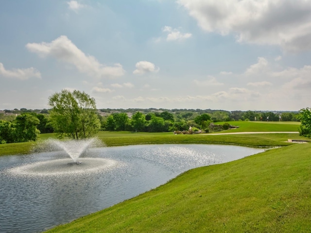 view of property's community featuring a water view and a yard