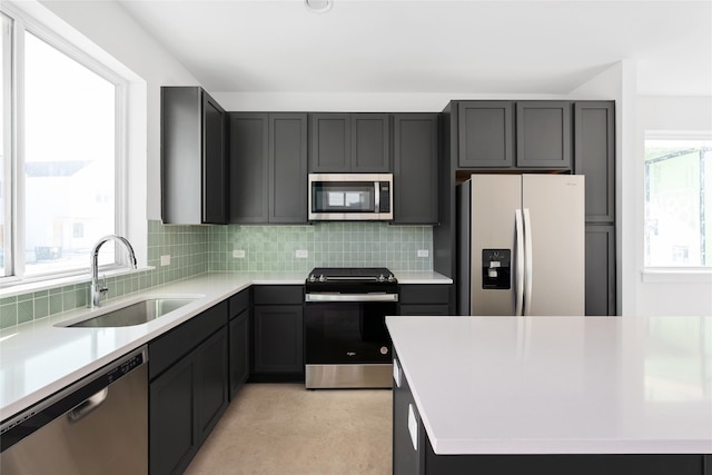 kitchen with stainless steel appliances, tasteful backsplash, and sink