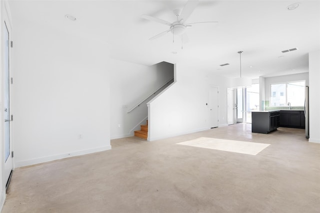 unfurnished living room featuring ceiling fan