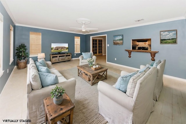 living room with ornamental molding, ceiling fan, and light wood-type flooring