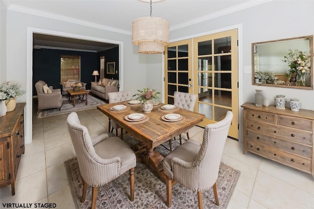 dining space featuring french doors, ornamental molding, a chandelier, and light tile patterned floors