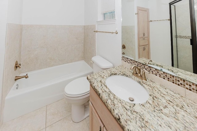 bathroom featuring tile patterned floors, toilet, vanity, and a washtub