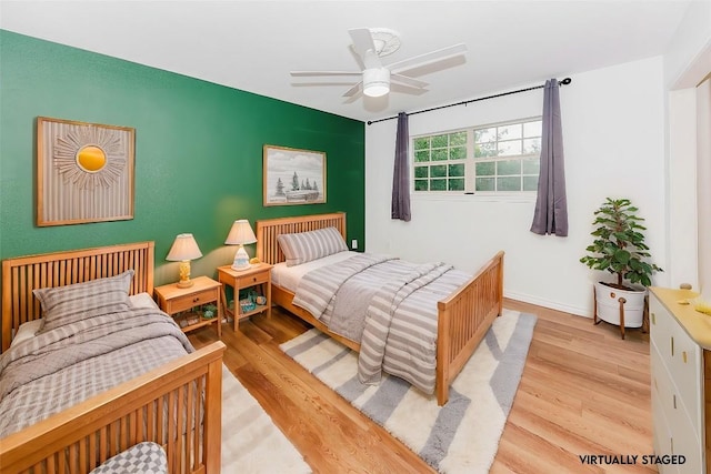 bedroom with ceiling fan and light hardwood / wood-style flooring