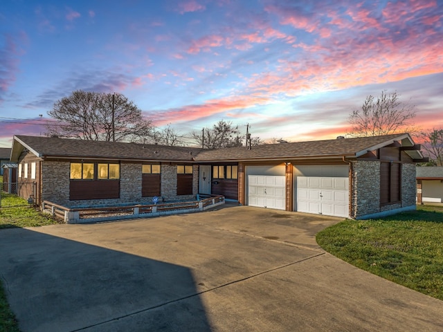 ranch-style house featuring a yard and a garage