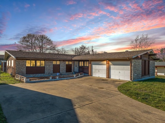 view of front of house featuring a garage, stone siding, and concrete driveway