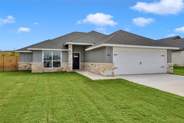 view of front of home with a front lawn and a garage