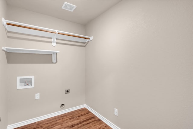 laundry room with hookup for an electric dryer, hardwood / wood-style floors, and washer hookup