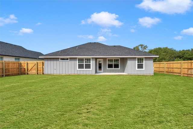 rear view of property with a yard and a patio area