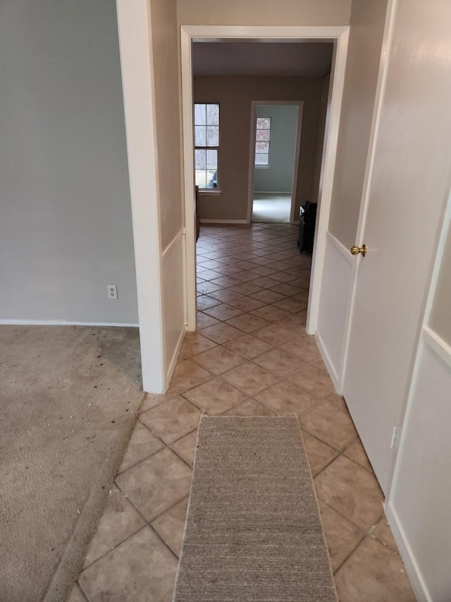 hall featuring light tile patterned floors