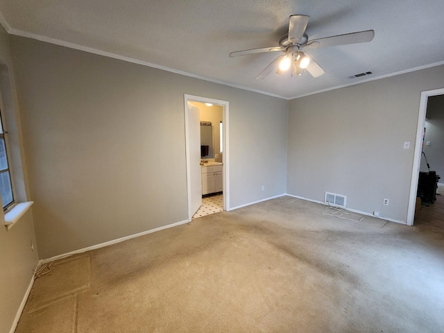 unfurnished bedroom with light carpet, ornamental molding, ceiling fan, and ensuite bathroom