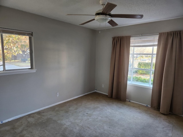 spare room with light colored carpet and ceiling fan