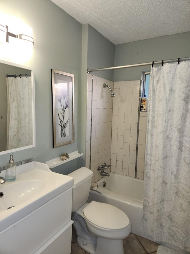 full bathroom featuring vanity, toilet, tile patterned floors, a textured ceiling, and shower / bath combo with shower curtain