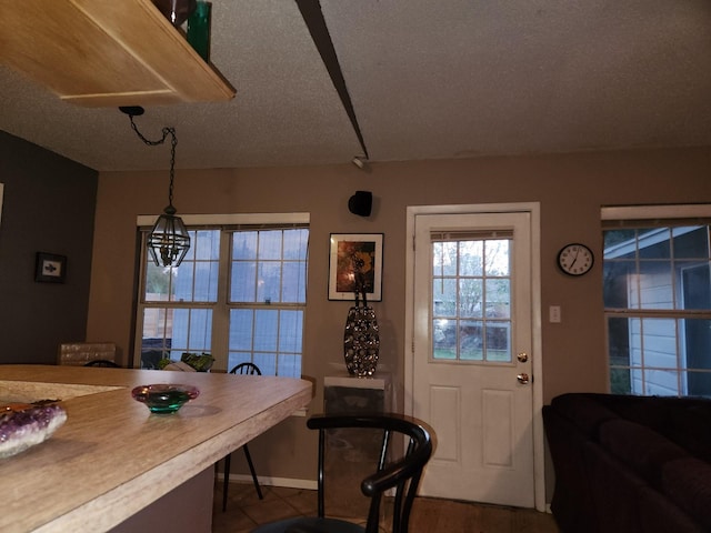 dining area with a chandelier and a textured ceiling