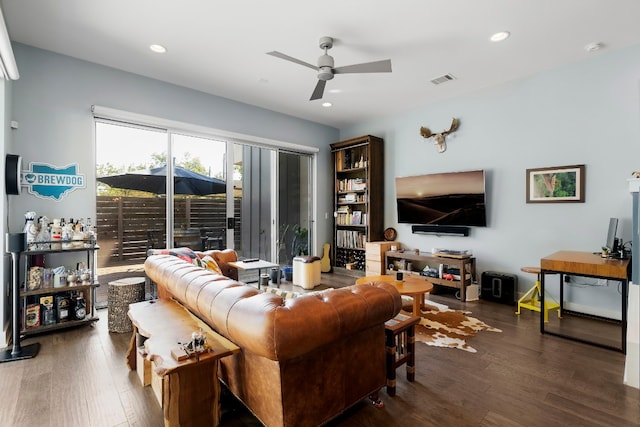 living room featuring ceiling fan and dark hardwood / wood-style floors