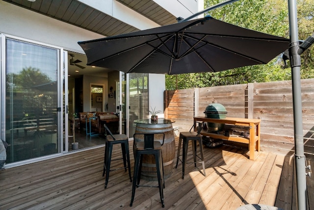 wooden terrace with fence and outdoor dry bar