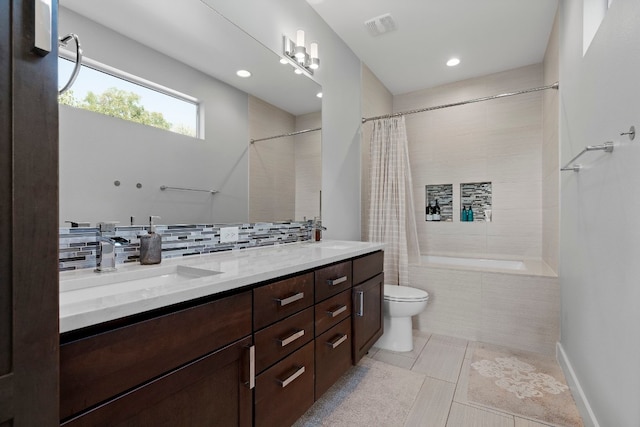 full bathroom featuring tile patterned flooring, tasteful backsplash, shower / tub combo with curtain, toilet, and vanity