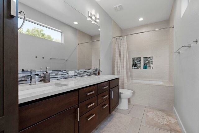 full bathroom featuring toilet, tile patterned floors, a sink, and visible vents