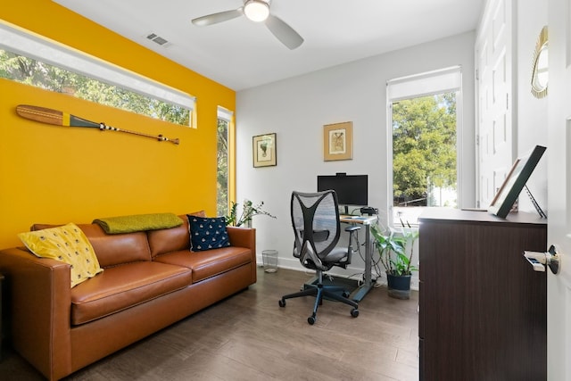 office with wood finished floors, a healthy amount of sunlight, a ceiling fan, and visible vents