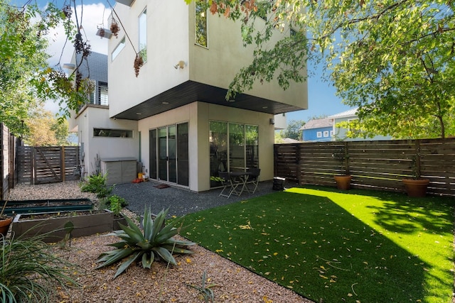 2108 Brackenridge St Unit B, Austin, TX 78704 - rear view of house with stucco siding and a garden
