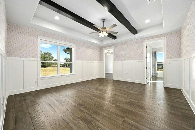 unfurnished living room featuring ceiling fan and dark hardwood / wood-style flooring