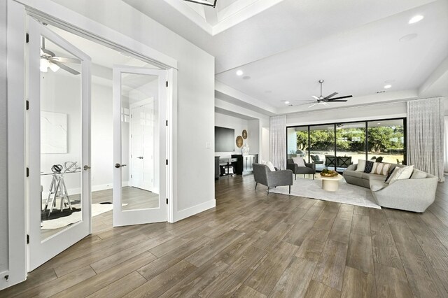 living room with wood-type flooring and ceiling fan