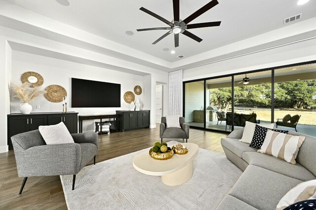 living room with wood-type flooring and ceiling fan