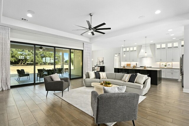 living room with wood-type flooring and ceiling fan