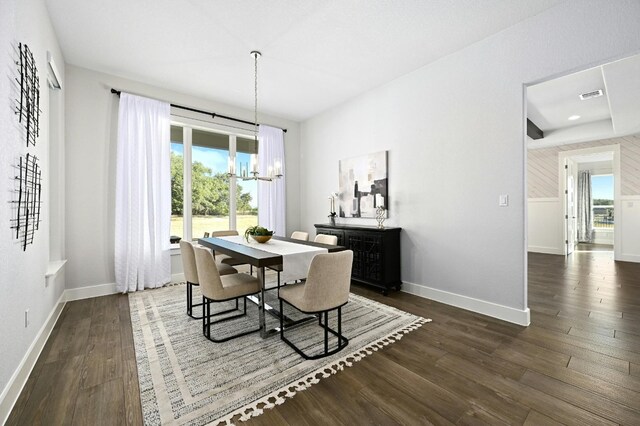 dining space featuring an inviting chandelier and dark hardwood / wood-style floors