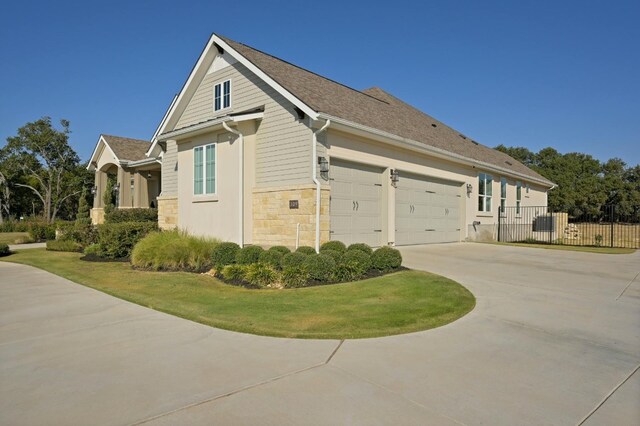 view of home's exterior with a yard and a garage