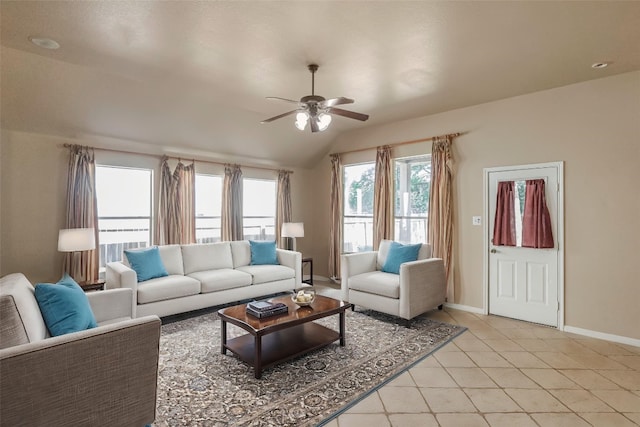 living room featuring vaulted ceiling, ceiling fan, light tile patterned flooring, and plenty of natural light