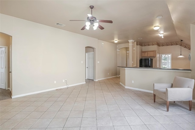 unfurnished living room with lofted ceiling, light tile patterned floors, and ceiling fan