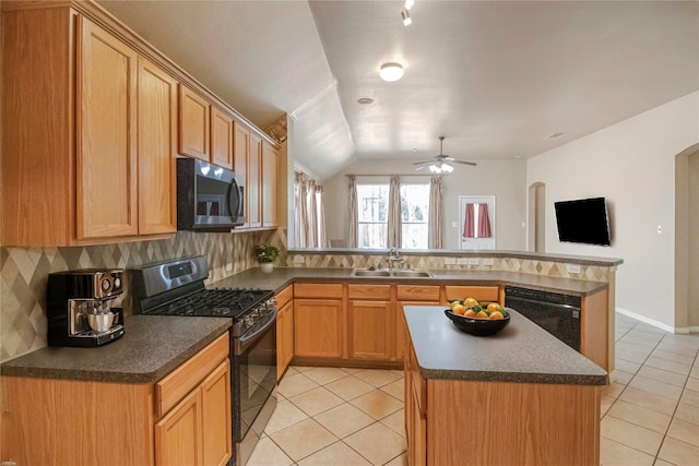 kitchen with lofted ceiling, tasteful backsplash, black appliances, and sink