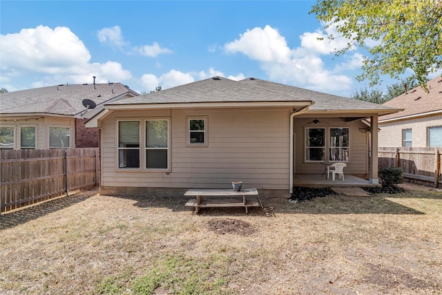 rear view of property featuring a patio area and a yard