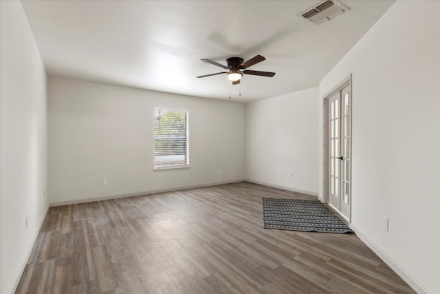 empty room with french doors, hardwood / wood-style flooring, and ceiling fan