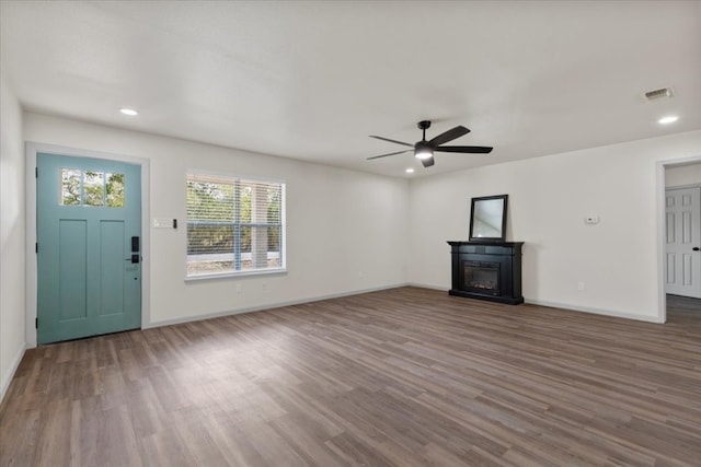 unfurnished living room with ceiling fan and hardwood / wood-style flooring