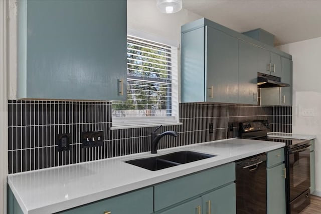 kitchen featuring sink, black appliances, wood-type flooring, and tasteful backsplash