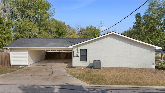 view of property exterior featuring central AC, a yard, and a carport